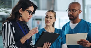medical-team-tablet-meeting-clinic-advice-innovation-feedback-with-patient-report-hospital-ceo-people-tech-lobby-with-results-solution-professional-opinion-healthcare